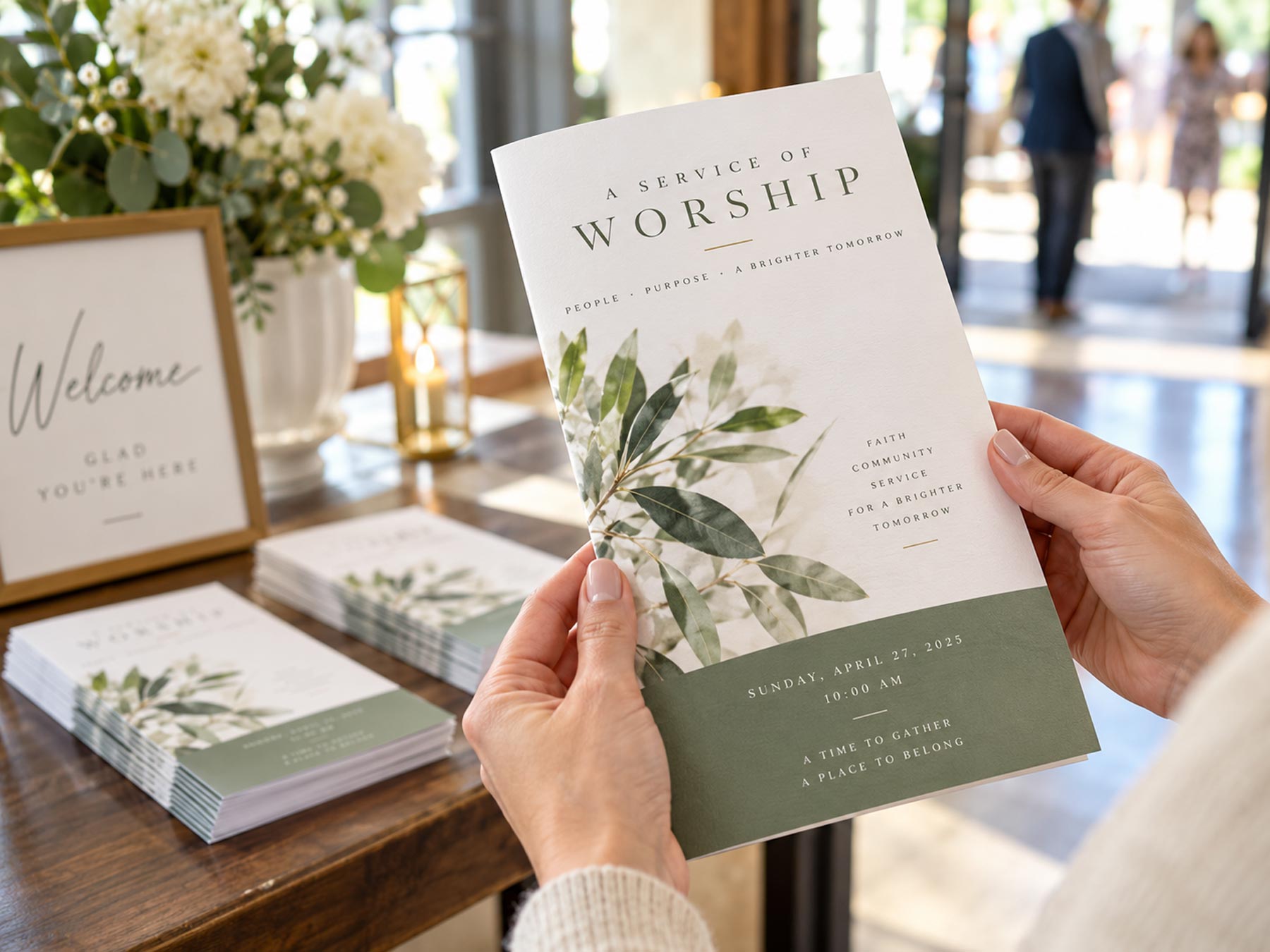 Hands holding a printed program in a bright, church setting